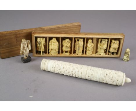 A Chinese carved bone etui, together with a set of Japanese carved ivory okimono of the seven Lucky Gods, a miniature okimono