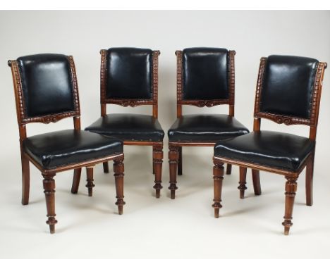 A set of four Victorian mahogany panel back dining chairs, circa 1880, each with black padded panel back and over stuffed sea