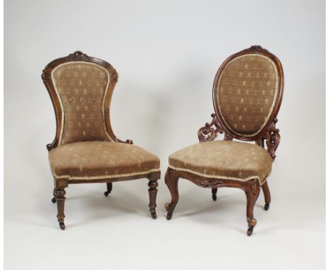 Two Victorian walnut nursing chairs, third quarter 19th century, one with oval back and foliate surmount and scroll open brac