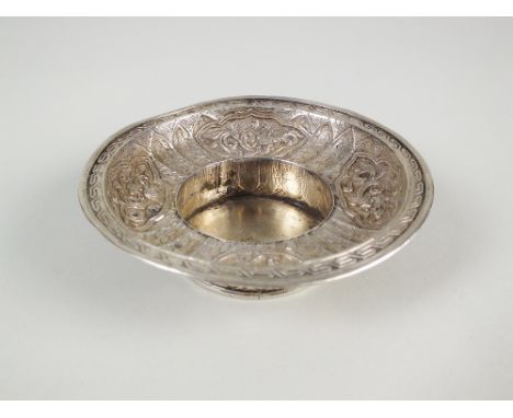 A 19th century Chinese/Tibetan silver cup or bowl stand, the embossed decorated bowl on a stylised lotus base, stamped to und
