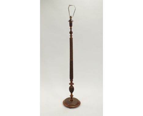 An oriental carved hardwood standard lamp, fitted for electricity the column carved with fruiting vine, height of column, 153