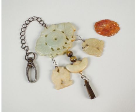A Chinese jade pendant on chain and a further amber jade pendant
