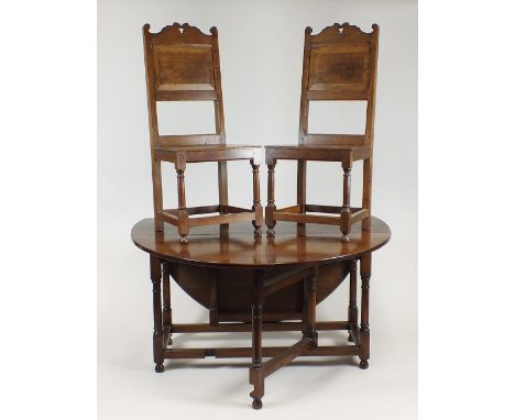 A cabinet made Cromwellian style oak dining room suite by R C Davies of Cold Hatton, Shropshire, comprising a large oval drop