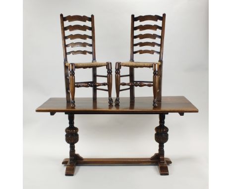 An oak dining room suite comprising refectory table on cup and cover legs and bar feet, 168cm long, 75cm wide, four rush seat