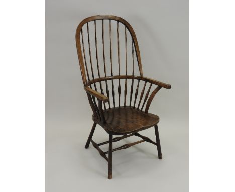 An ash and elm stick back Windsor chair, late 19th century, with high hooped back and raised on ring turned splayed legs join