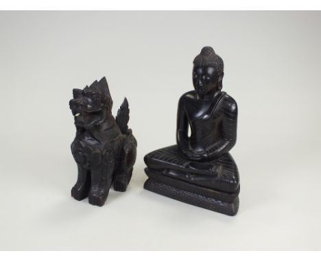 Two South East Asian carved hardwood figures, the first of a seated Buddha, 29.5cm high, the second a seated guardian lion, 2