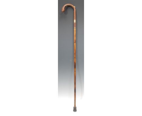 An early 20th century novelty walking stick, by Brigg, London, the curved handle enclosing a pencil, bamboo cane, the gilt me