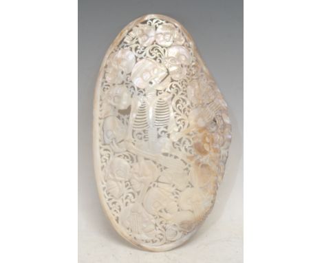 The Macabre - an Indonesian mother of pearl (pyganodon grandis) shell, pierced and carved with a skeleton and skulls, 26.5cm 