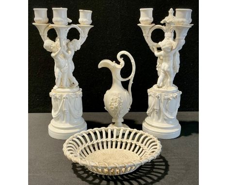 A pair of Minton blanc de chine three branch candelabra, modelled with three putti, on a columnar base, 36.5cm high, impresse