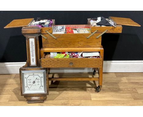 A mid 20th century oak concertina action sewing box, with base drawer, assorted contents ;  an oak barometer (2)