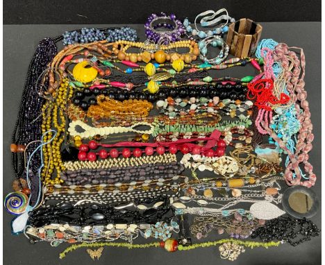 A mixed selection of Costume Jewelleryto include; wooden bead, glass bead and plastic bead necklaces, bracelets, brooches and