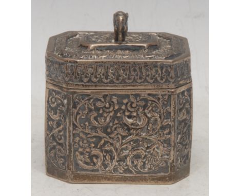 A 19th century Indian silver canted rectangular tea caddy, chased and engraved with leafy scrolls in relief, hinged cover wit