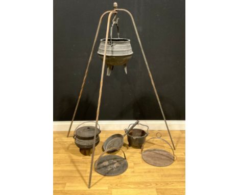 A Falkirk cast iron tripod cauldron and cover, size 2, 25cm high; a cast iron tripod smelting pot, 35cm high over swing handl