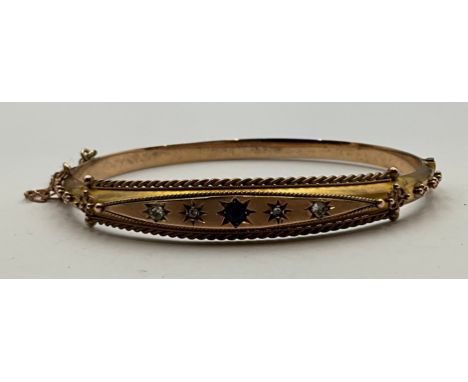 A 9ct Rose Gold Blue and Colourless Paste Stone and Diamond Half Hinged Bangle;stamped "9 375", measures approx. 5.7cm inside