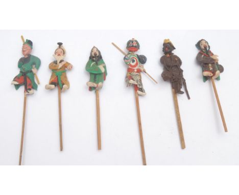A set of six Japanese clay stick puppets, the tallest 16.5cm long