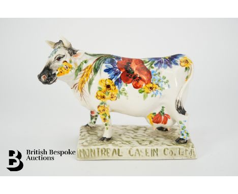 A ceramic polychrome cow advertising the Montreal Casein Co dairy company, manufactured in Italy, approx 17.5 x 14 cms.&nbsp;