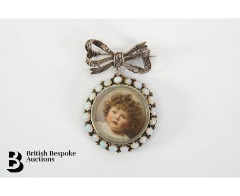 A silver and opal portrait miniature locket. The miniature framed with twenty opals, the portrait measures 25 x 25mm and the 