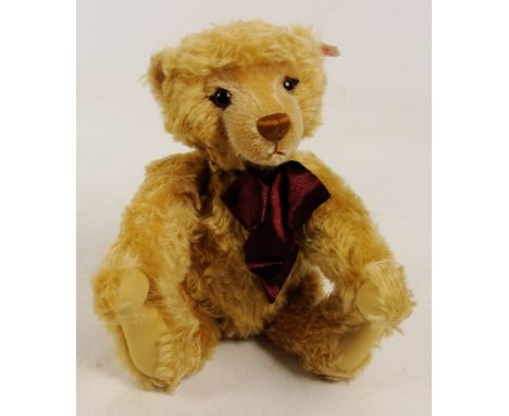 A boxed Steiff 2000 Millennium teddy bear, no. 670374, with numbered white and red tag to ear, with curly blonde mohair fur a