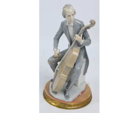 A Lladro model of a seated cellist mounted on associated plinth, height including plinth 35.5cm. CONDITION REPORT: General co