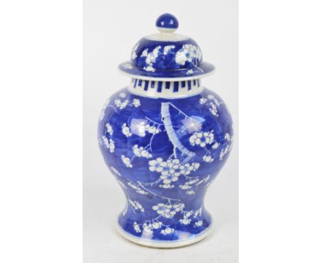A late 19th century Chinese baluster jar and cover painted in underglaze blue with blossoming prunus, four character Kangxi m