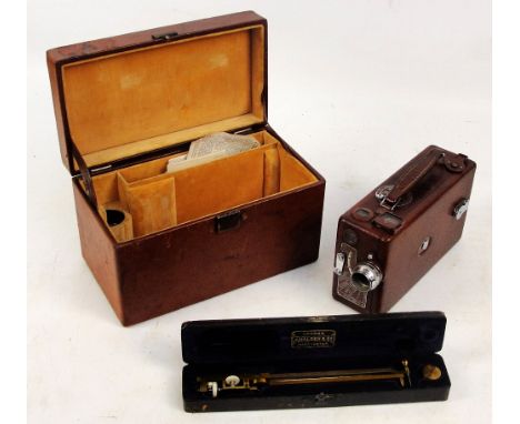A vintage leather cased Cine Kodak camera, Model B, length 21.5 cm, the case fitted with lenses and with manuals, and a cased