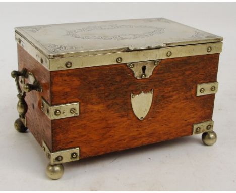 An Edwardian oak twin handled tea caddy with electroplated mounts and hinged lid enclosing two division lidded interior, with