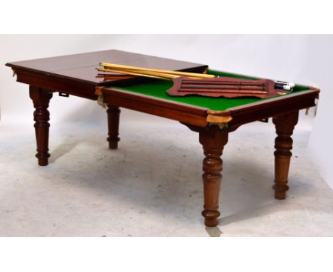 A half size combination slate bed billiards/dining table, the top with mahogany leaf covers above the baize playing surface r