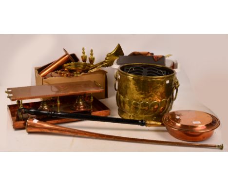 A large quantity of copper and brass including a Dutch brass jardinière with lion mask ring handles, coaching horn, warming p