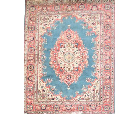 A Turkish Konya wool carpet with floral decoration on a pale green central panel and pale terracotta border, 273 x 368cm.