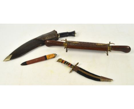 A kukri knife in leather scabbard with two additional smaller knives and ebonised handle, length 42.5cm, a Swedish Army Mora 