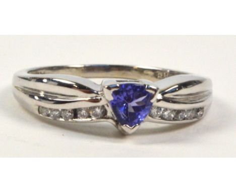 A 14ct white gold ring, set with triangular tanzanite flanked by five small diamonds to each shoulder, size Q/R, with origina