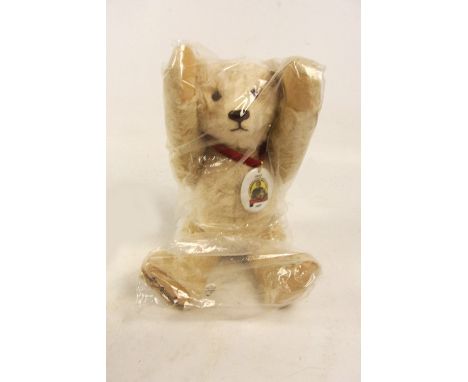 A boxed Steiff Jubilee teddy bear, no. 670152, with numbered white and red tag to ear, with off-white mohair fur and ceramic 