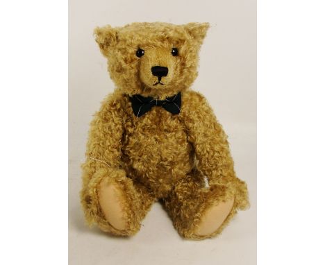 A boxed Steiff Henderson teddy bear, no. 653780, with numbered white and red tag to ear, with blonde mohair fur and Henderson