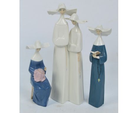 A Lladro figure group of two nuns, height 33cm and two further Nao figures of nuns (3). CONDITION REPORT: Medium height figur