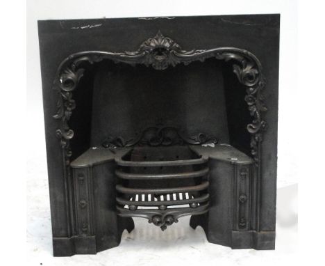 A Victorian cast iron fire insert with scrolling surround and angled grate, width 92cm, height 96.5cm.