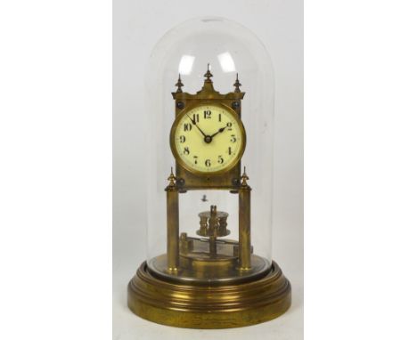 An early 20th century brass anniversary clock by Gustav Becker, the movement no. 2194386 , on circular base, beneath a glass 
