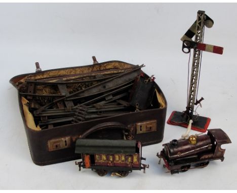 A vintage Hornby Meccano O gauge clockwork part train set comprising engine, tender (without wheels), carriage, signals, and 