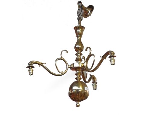 A brass three light ceiling light with three frosted shades.