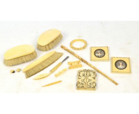 A group of late 19th and early 20th century ivory items including a diptych carved Chinese frame, three brushes, a long chero