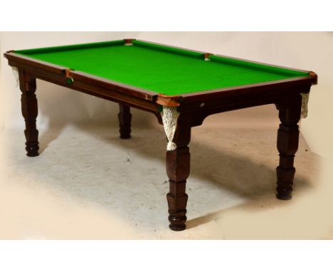 A half size slate bed billiard table raised on square section supports, sold with a circular cue and rest stand, various acce