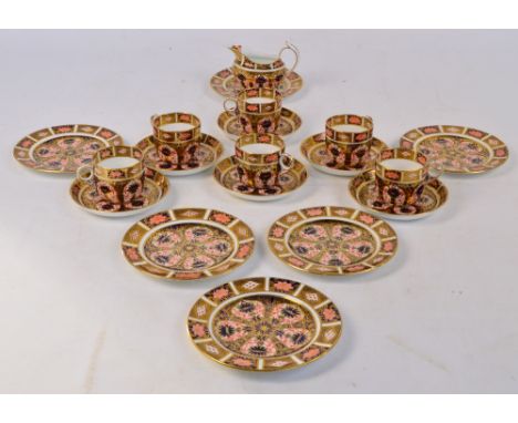 A set of six Royal Crown Derby Imari decorated cups, saucers and side plates, pattern 1128, and a matching cream jug. CONDITI