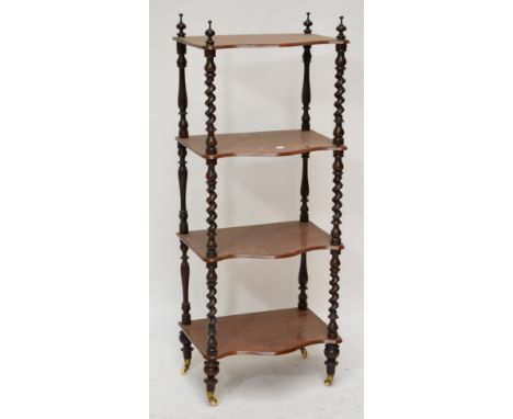 A Victorian walnut whatnot, the four serpentine shaped tiers on barleytwist column supports, width 51cm, height to top of fin