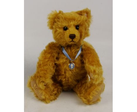 A boxed Steiff 2002 Golden Jubilee teddy bear no. 660610, with numbered white and red tag to ear, with curly golden mohair fu