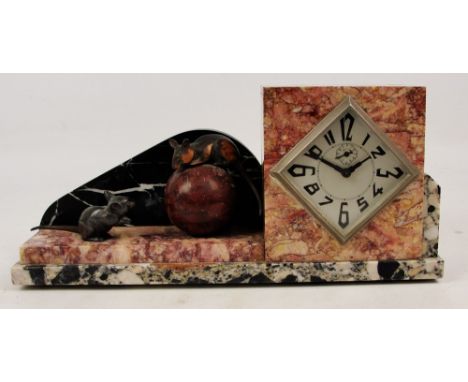 A French Art Deco mantel clock with various coloured marbles, the lozenge shaped dial set with stylised Arabic numerals and a