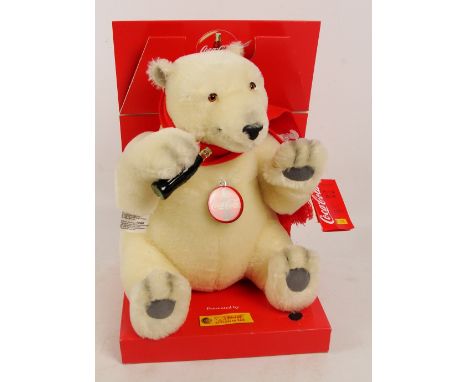A boxed Steiff Coca Cola sitting polar bear, no. 670336, with numbered white and red tag to ear, with white mohair fur with r