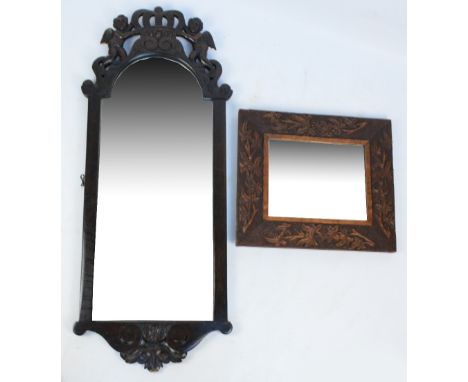 A carved oak rectangular wall mirror with central bevelled plate, 39.5 x 34.5cm, and a 20th century carved oak wall mirror wi