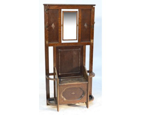 A 1940s oak hall stand with central box seat and hinged lid flanked by two umbrella/stick stands, with swing bevelled mirror 