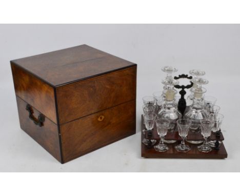 A late 19th century French walnut and string inlaid decanter box with pull-out mahogany stand with cast central handle, conta
