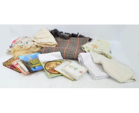 A quantity of various textiles including an Edwardian silk embroidered throw with long tassels, a vintage blanket, a collecti