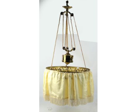 A circular brass rise and fall ceiling light, the frame with heart shaped motifs bearing three lamp fitments, with fringed si